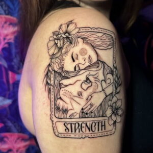 Cropped version of Megan Bond's strength tarot card scar cover up tattoo