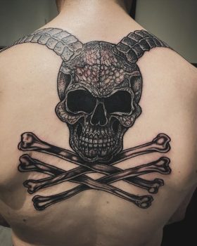 Started a refresh on this old skull and added some crossed bones - a tattoo by Paul Cooke from Ashton Ink Tattoo Studio - tattooist Oldham