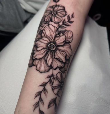 Close up image from this floral scar cover up done by Symone from Ashton Ink Tattoo Studio - tattoo shops tameside